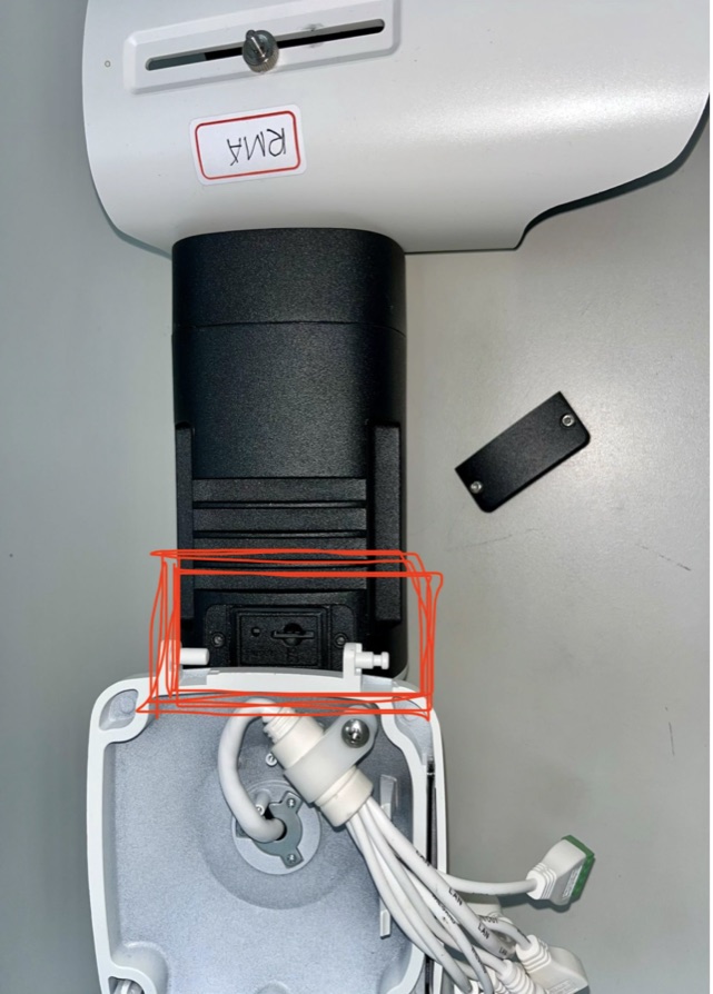 Camera underside with the protective plate removed, exposed chamber with the Micro SD card slot highlighted